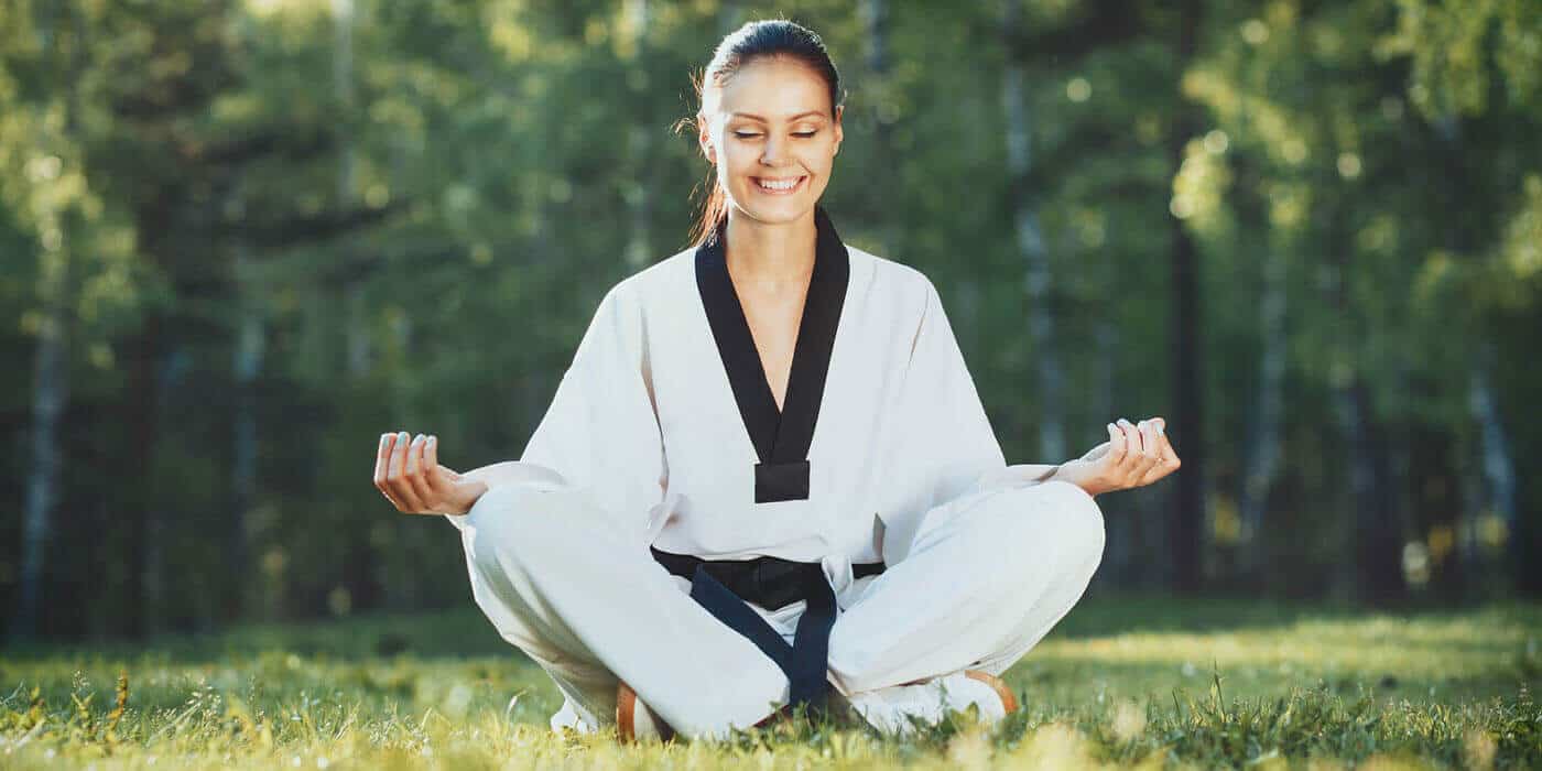 Martial Arts Lessons for Adults in Taylor TX - Happy Woman Meditated Sitting Background