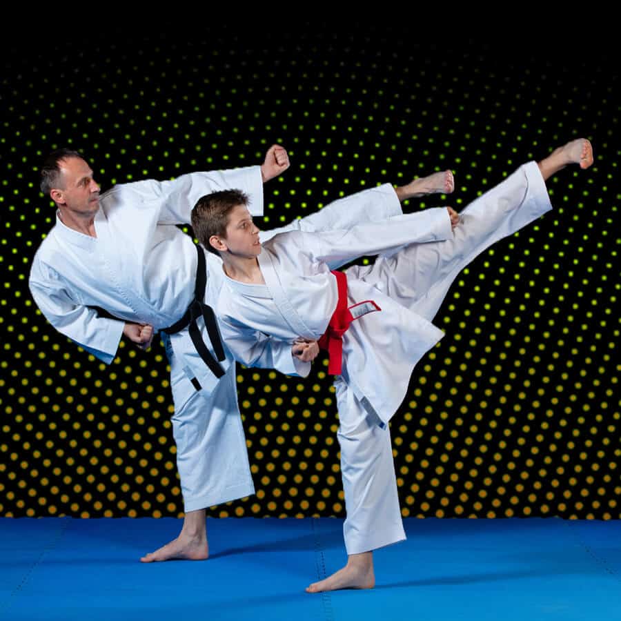 Martial Arts Lessons for Families in Taylor TX - Dad and Son High Kick